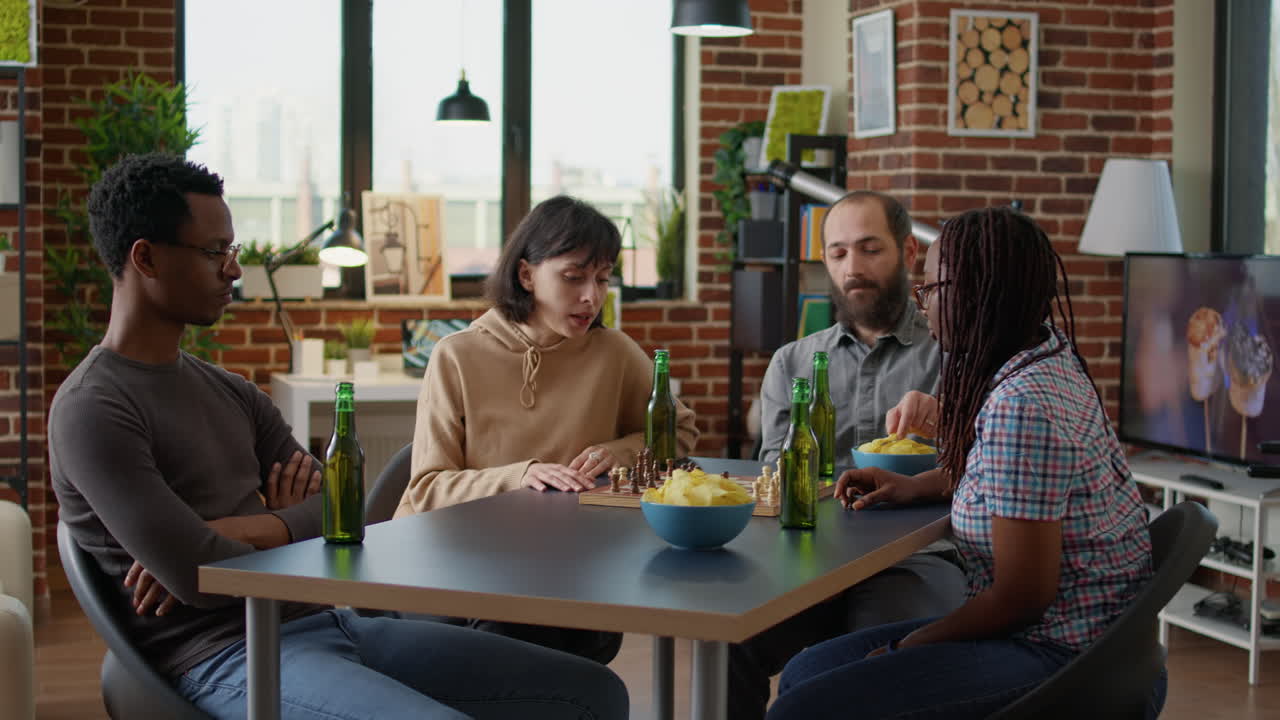 Young people playing board games together in apartment
