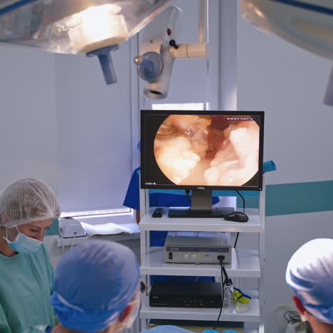 operating theatre with video camera technology. medical surgical team performing laparoscopic surgery on the patient. contemporary equipment in medicine.