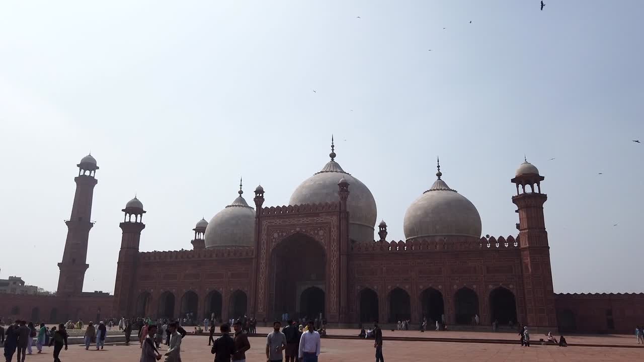 Pan Shot Of Badshahi Mosque From the Inside With People And Flying Birds in Lahore Pakistan