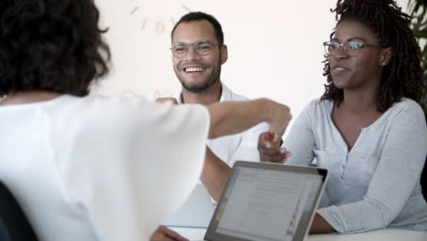 smiling people shaking hands in office.