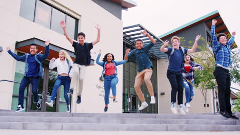 group of high school students jumping in air outside college buildings