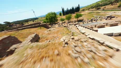 Aerial-view-theater-of-the-Asclepion,-in-front-of-which-are-several-stone-framed-sacred-pools