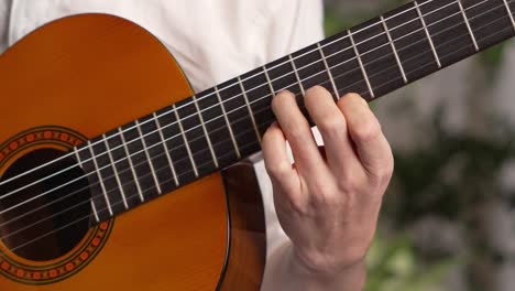 guitarist plucking the strings on his instrument