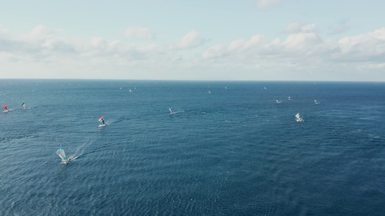 Bali fishing boats returning from blue tropical sea, crab claw sails, aerial
