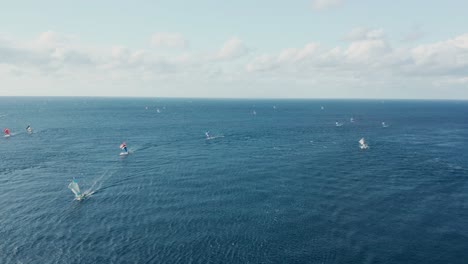 bali fishing boats returning from blue tropical sea, crab claw sails, aerial