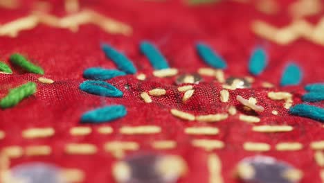 Close-up of intricate embroidery on red fabric