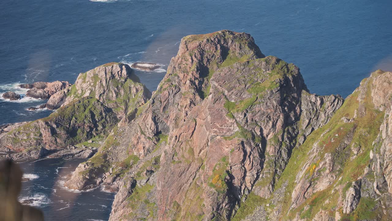 Majestic coastal cliffs towering over the ocean, set in Måtinden Vestarelen, Norway with clear waters