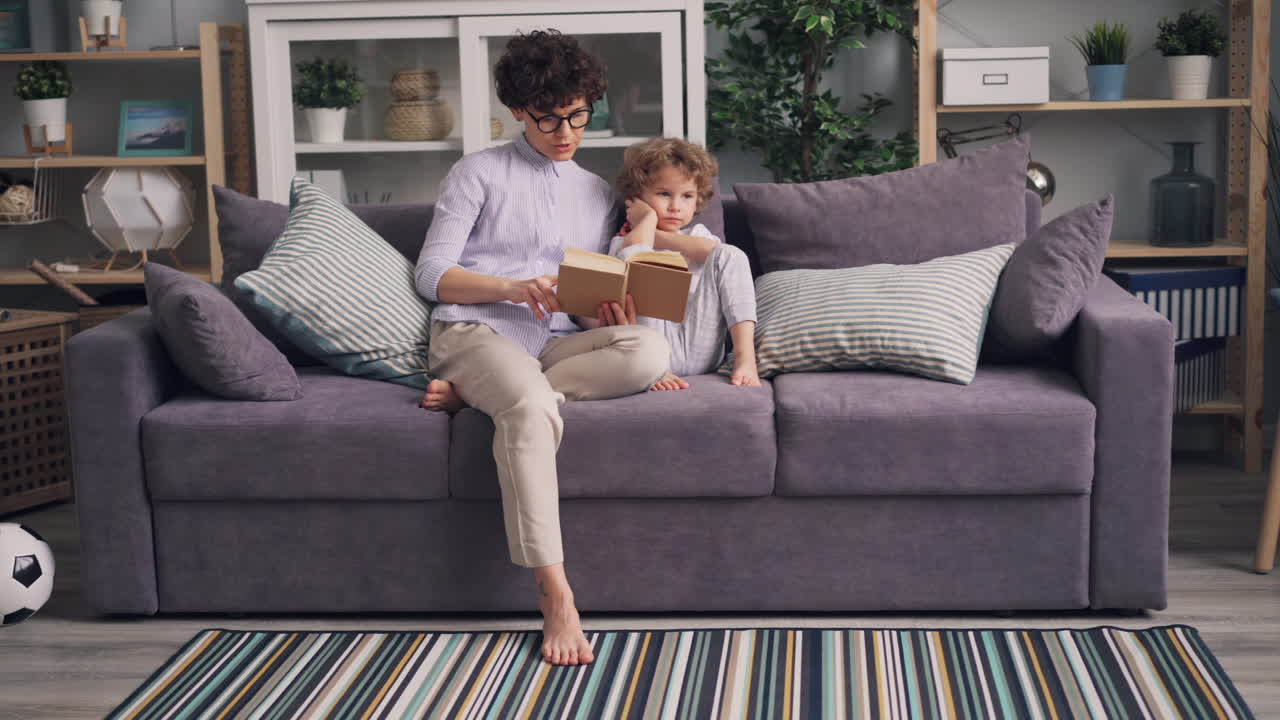 Mother and Son Reading Together on a Couch