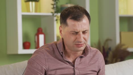 the sick man coughs, begins to hold his aching chest.