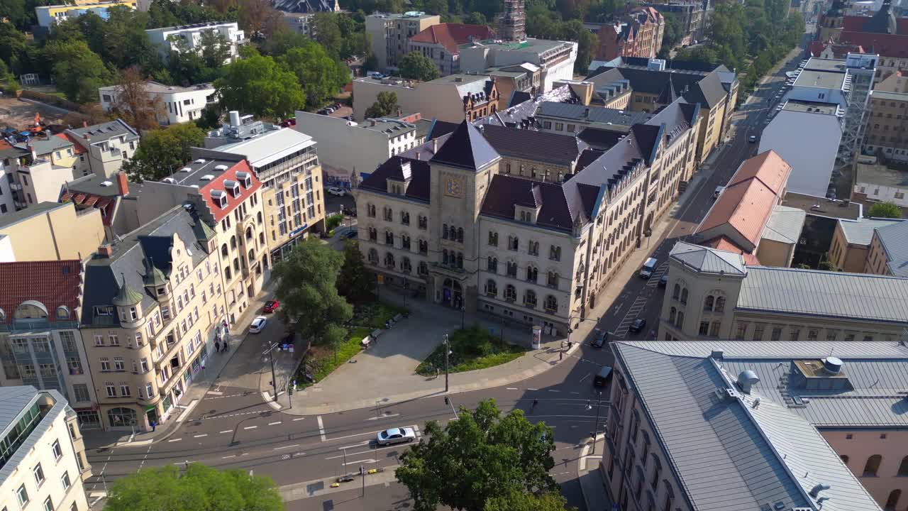 city of halle saale in germany, showing the historic post office building surrounded by apartment buildings. overflight flyover drone
