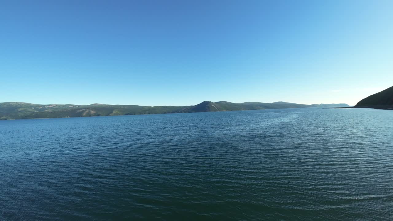 Enjoy a serene lake and mountain view from a breathtaking aerial perspective