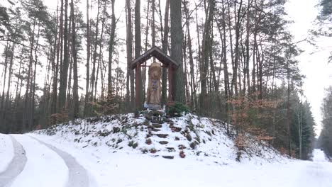 hand crafted wooden sculpture of mary on the crossroad