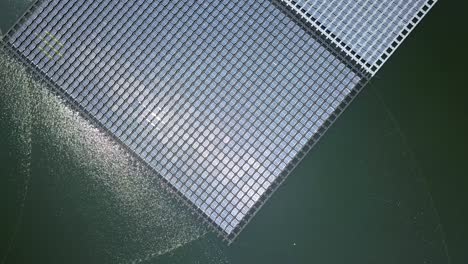 aerial view of floating solar farm or solar panels on the water in industrial estate.