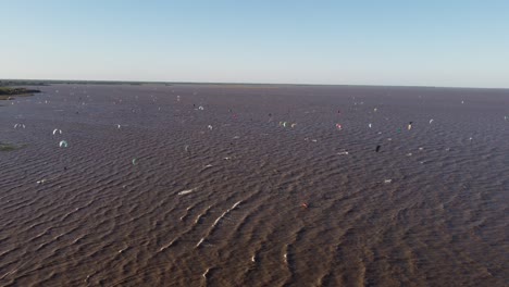 stunning shot of kite surfers on river at sunset, vicente lopez area, buenos aires, rio de la plata