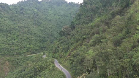 soar over a beautiful river that winds through a canyon in ha giang’s thick jungle. experience the stunning natural beauty of vietnam’s rugged wilderness from above.