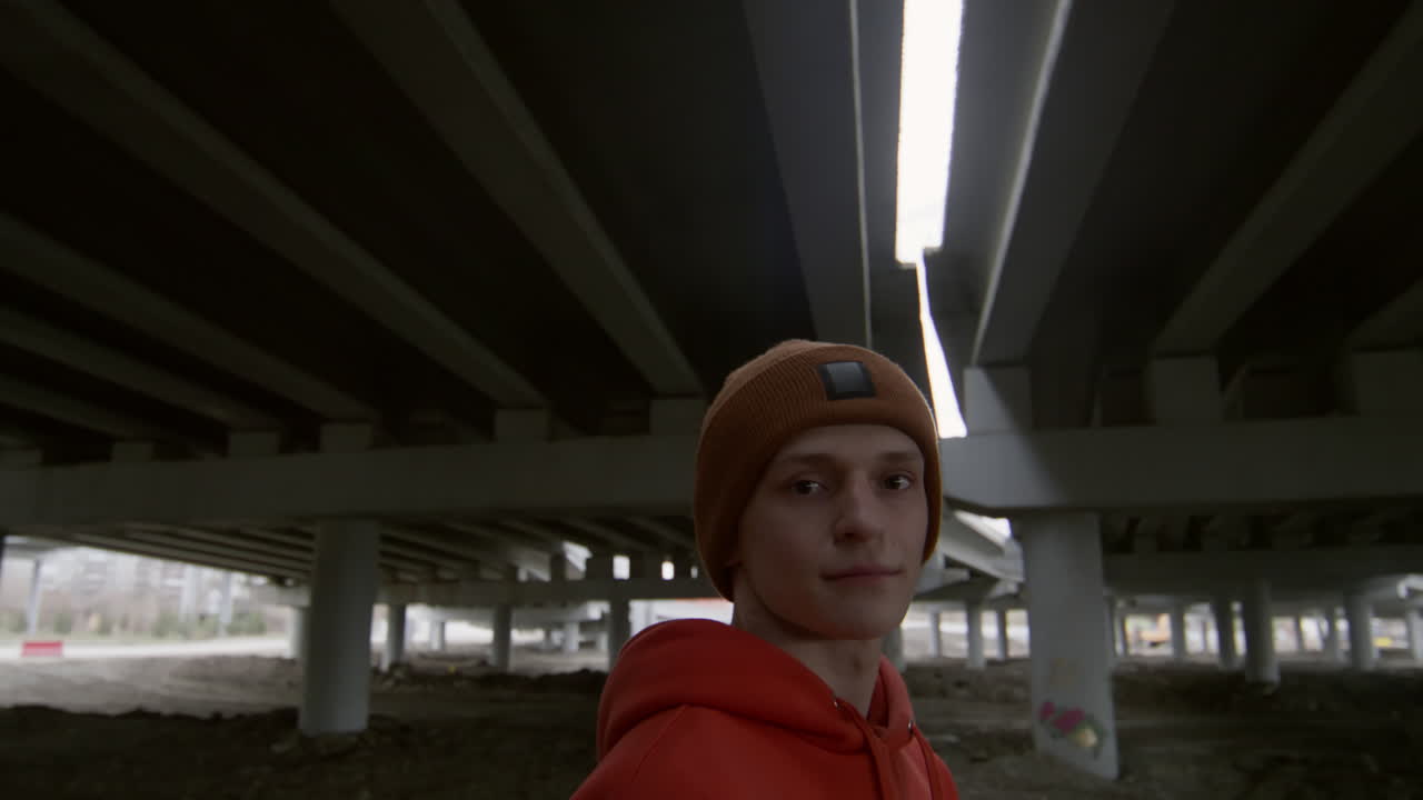 Portrait of Boy in Streetwear under Urban Bridge