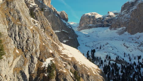 Drone-footage-showcasing-the-dramatic-snowy-cliffs-and-rugged-terrain-of-the-Dolomites