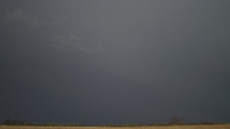 lightning streaks in the sky during a storm. - wide shot