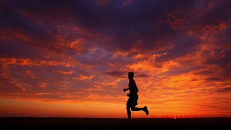 athlete running under a fiery sunset sky