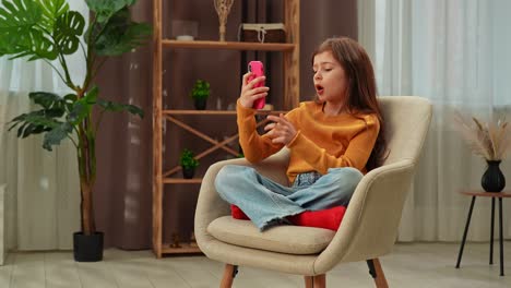 girl using a smartphone in a chair