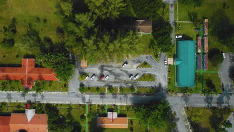 Cinematic-Drone-Footage-of-Palm-Oil-Mill-Effluent-residential-consists-of-buildings,-homes,-main-road-and-infrastructure-surrounded-by-palm-oil-trees-deforestation-located-in-Indonesia-in-full-HD