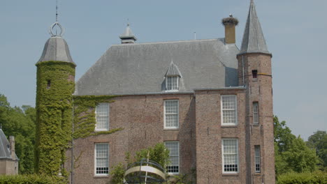 tilt up to castle zuylen seen from garden with armillary sundial in the foreground