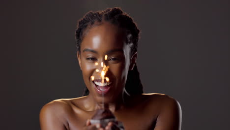woman celebrating with sparklers and cupcake