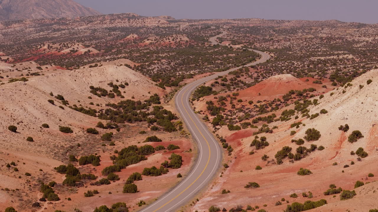 Desert Highway Winding Through Red Rock Mountains
