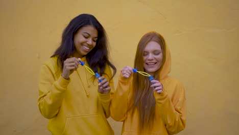 multi ethnic women blow soap bubbles