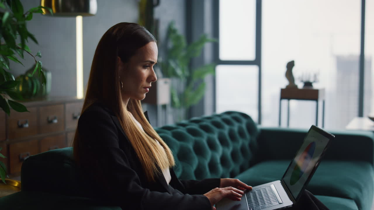 Businesswoman working on laptop at home office