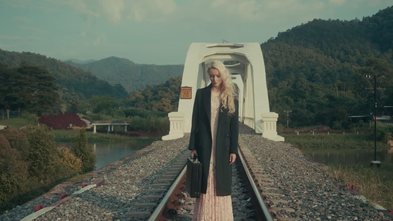Woman walking on a bridge over a river
