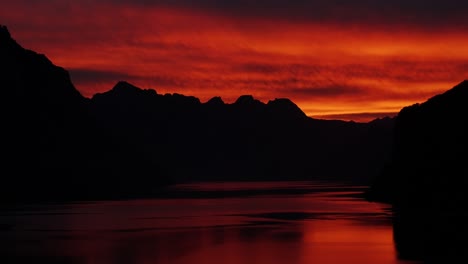 fiery sunset over mountains and lake