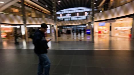 crowds moving through a busy train station