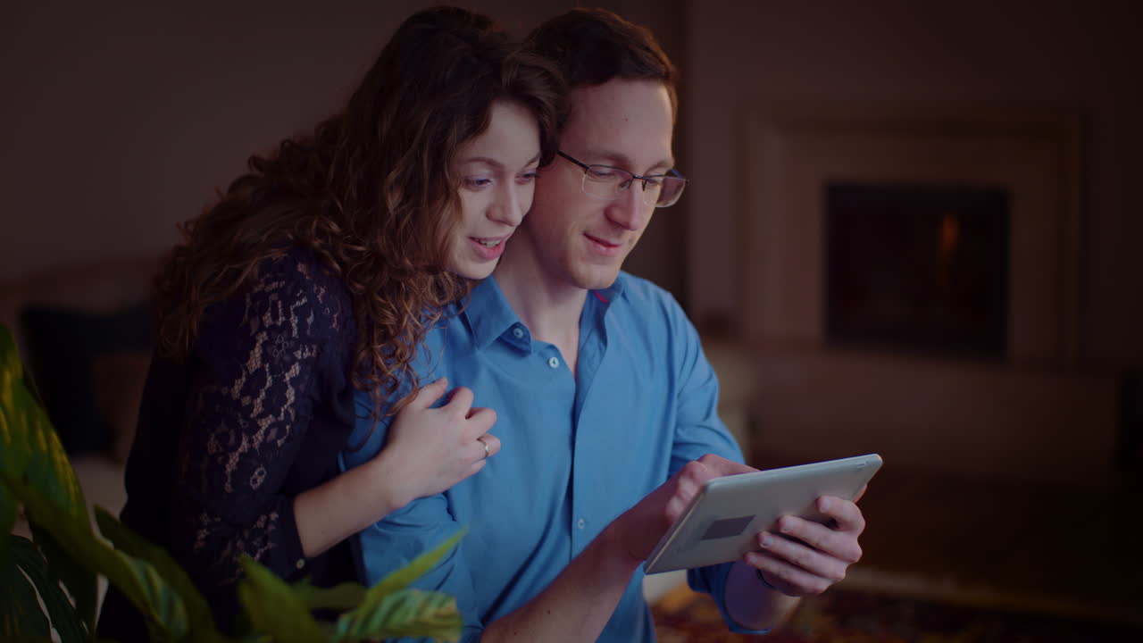 Couple using a tablet indoors