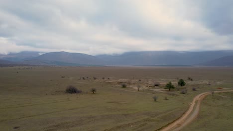 A-beautiful-landscape-drone-video-of-an-empty-countryside-field-in-Croatian-region-of-Lika-in-Croatia,-Europe