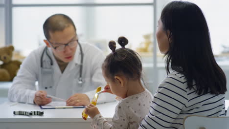 asian pediatrician consulting mother of little girl