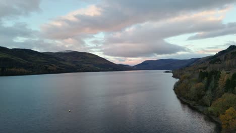 drone view during a beautiful autumn sunrise at loch earn in scotland