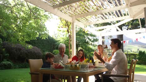 family eating outside together in summer