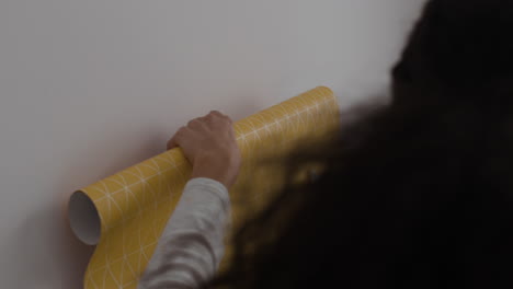 couple hanging wallpaper: home improvement project