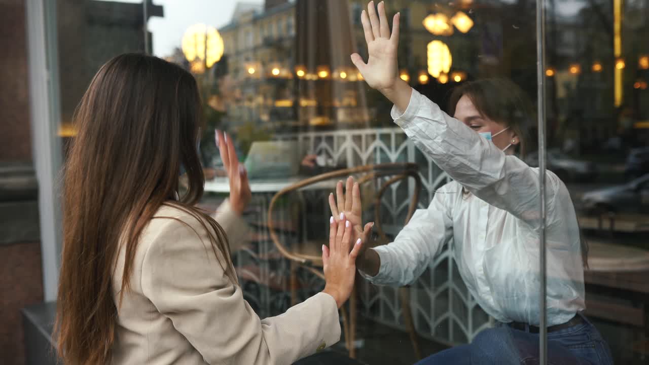 코로나19 팬데 기간 동안 카페 창문으로 인사를 하는 친구들