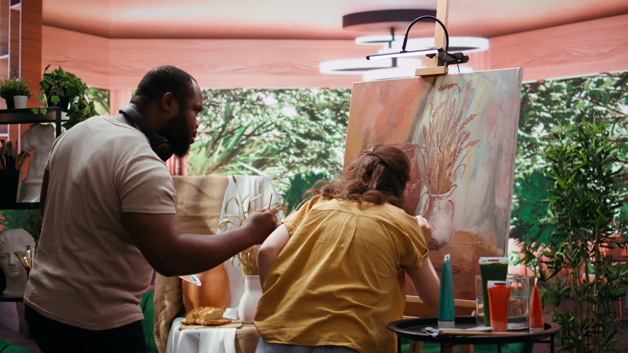 People painting still life art in a studio