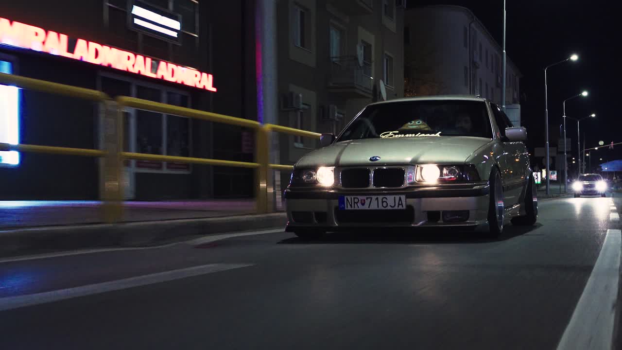 Touring on a third generation BMW coupe sedan car in the city center. Nitra City. Night.