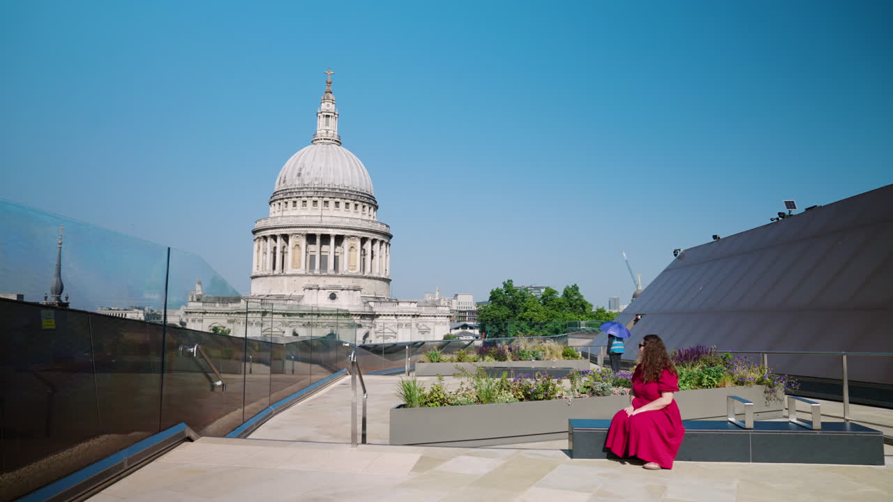 Woman In A Red Dress On Top Of A Building With St. Paul's Cathedral In London, United Kingdom. Wide Shot