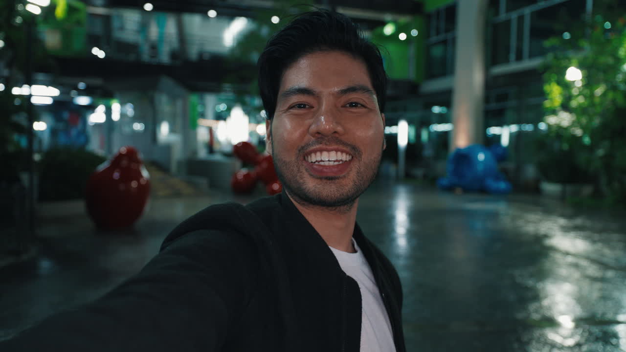 Happy Man Taking a Selfie at a Night Mall