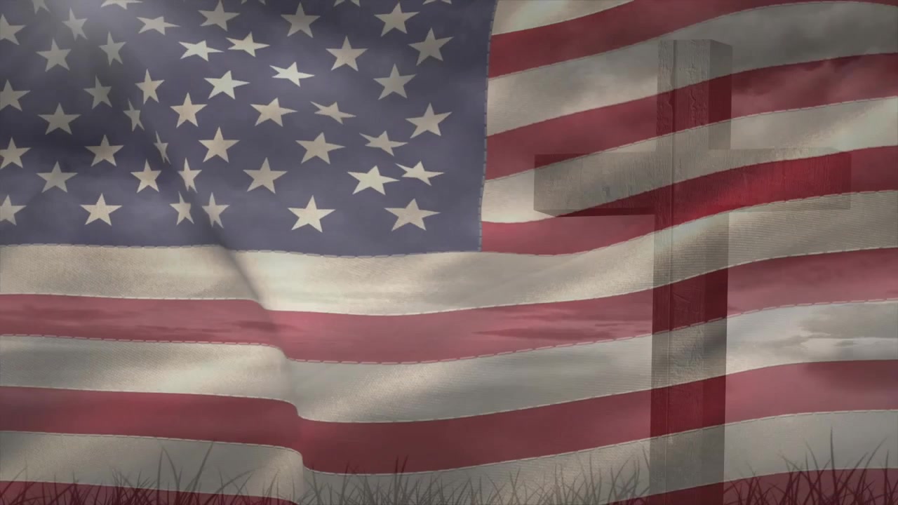 Viftende amerikansk flagg med et religiøst kors overlagret