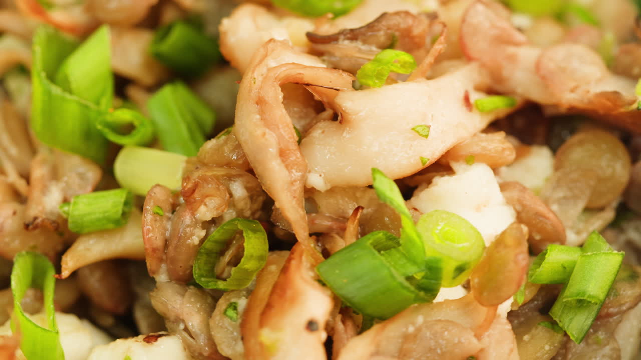 Close-up of sauteed mushrooms with spring onions