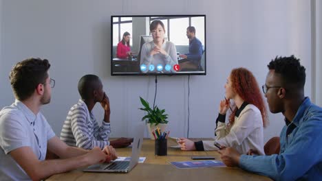 Creative-business-colleagues-in-video-conference-in-meeting-room-in-modern-office