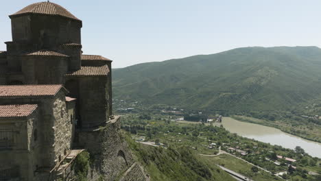 flying by the jvari monastery, georgian orthodox monastery on mountaintop overlooking mtkvari and aragvi river confluence in mtskheta, georgia