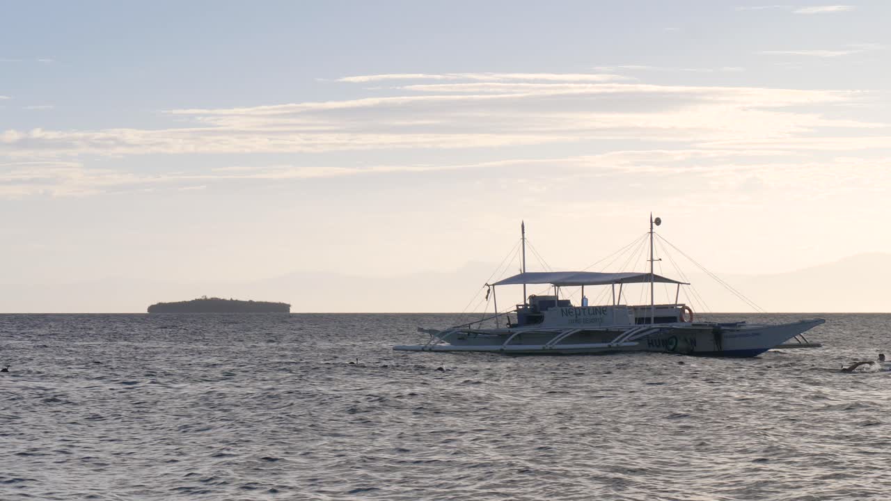 Floating Outrigger Boat On Tropical Sea Near Moalboal Municipality In Cebu, Philippines. Static Shot