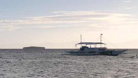 floating outrigger boat on tropical sea near moalboal municipality in cebu, philippines. static shot